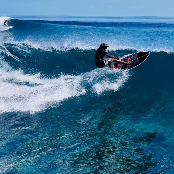 Malik Saeed surfing a right-hand reef break