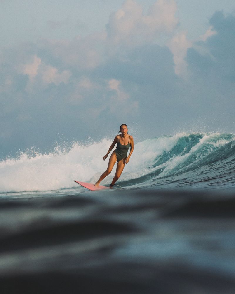 A surfer trimming across a clean face at Chickens, shot from the water